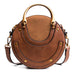 Brown round leather handbag with gold handles and a detachable crossbody strap
