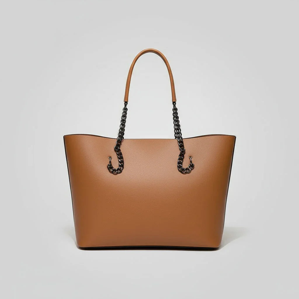 Brown leather tote bag with chain handles on a plain white background