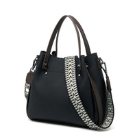 Black leather handbag with brown handles and a zigzag patterned shoulder strap