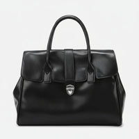 Black leather handbag with top handles and silver clasp on white background