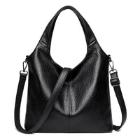 Black leather tote bag with adjustable shoulder strap and textured finish