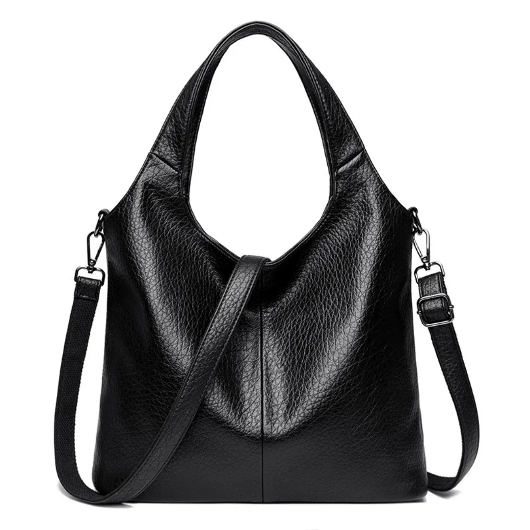 Black leather tote bag with adjustable shoulder strap and textured finish
