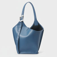 Blue leather bucket bag with silver buckle strap on white background