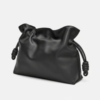 Black leather pouch bag with knotted drawstring, minimalist design on white background