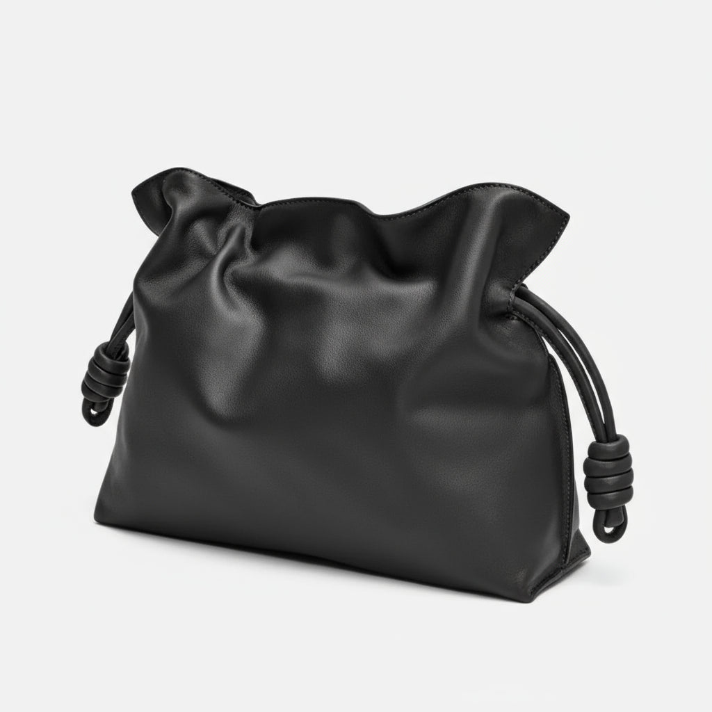 Black leather pouch bag with knotted drawstring, minimalist design on white background