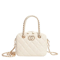 White quilted handbag with gold chain handles and decorative gold logo on front