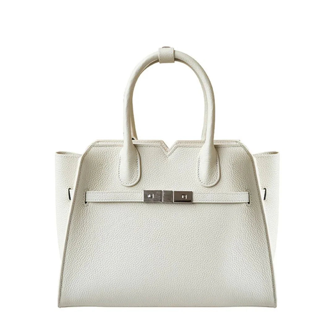 White leather handbag with structured shape and silver hardware handles, luxury purse