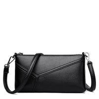 Black leather crossbody bag with detachable strap and geometric stitching details