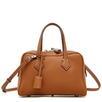 Brown leather handbag with shoulder strap and silver hardware on white background