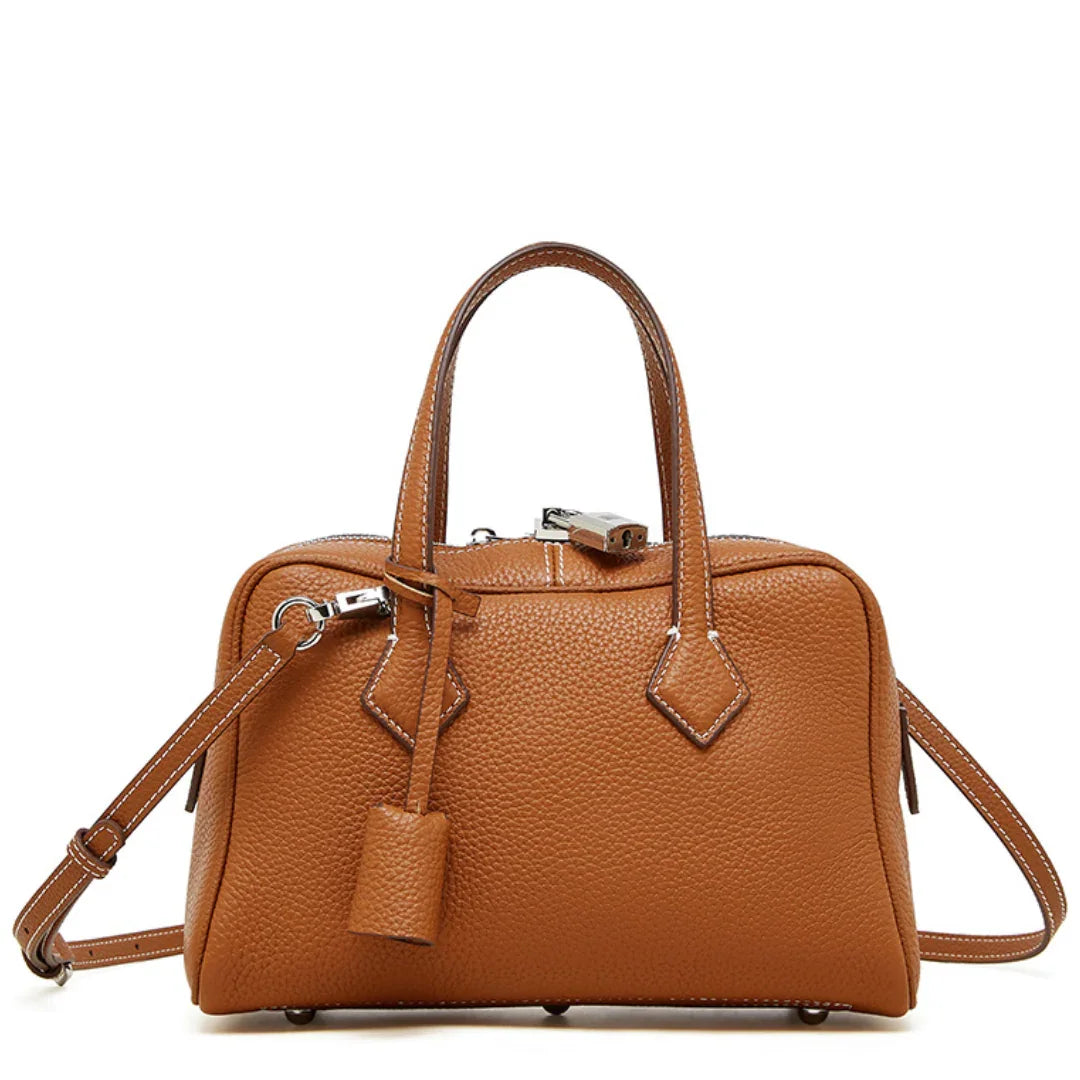 Brown leather handbag with shoulder strap and silver hardware on white background