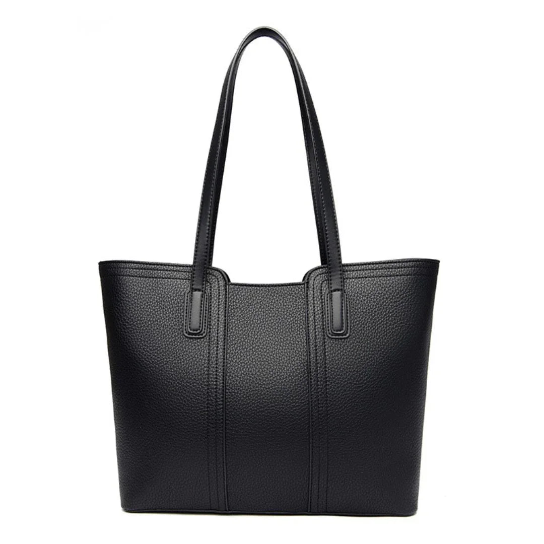 Black leather tote bag with double handles on white background