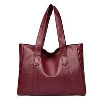 Burgundy leather tote bag with double shoulder straps on white background