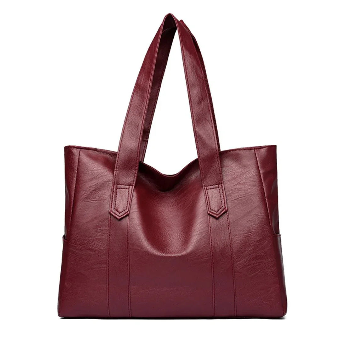 Burgundy leather tote bag with double shoulder straps on white background