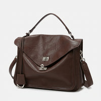 Brown leather satchel handbag with top handle, silver clasp, and detachable strap on white background