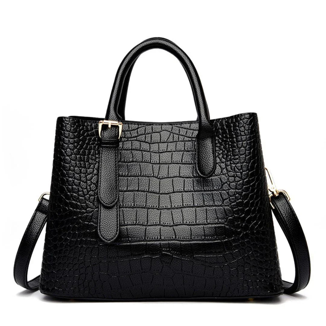 Black crocodile-embossed leather handbag with gold hardware and detachable strap