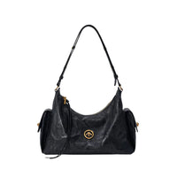 Black leather shoulder bag with gold zipper and round logo on white background