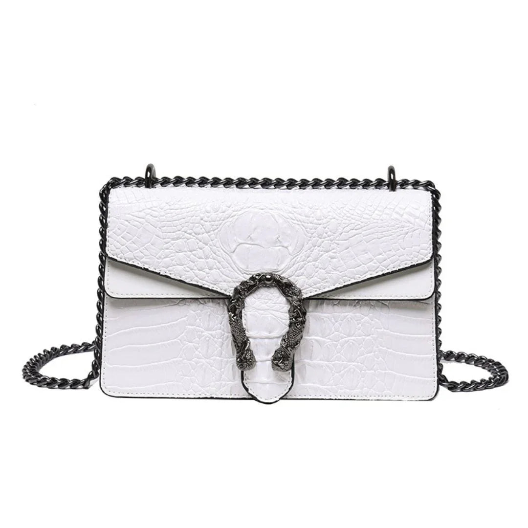 White crocodile-embossed leather shoulder bag with black chain strap and decorative metal clasp