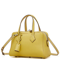 Yellow leather handbag with double handles and detachable shoulder strap on white background