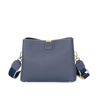 Navy blue leather crossbody bag with gold hardware and adjustable strap on white background