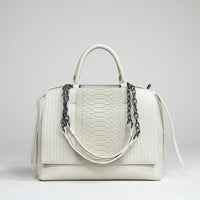 White leather handbag with textured snakeskin pattern and black chain detail