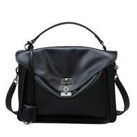 Black leather satchel handbag with top handle and silver clasp on white background