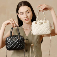 Woman holding black and white quilted handbags with gold chain straps