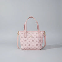 Light pink tote bag with patterned design and detachable shoulder strap on plain background