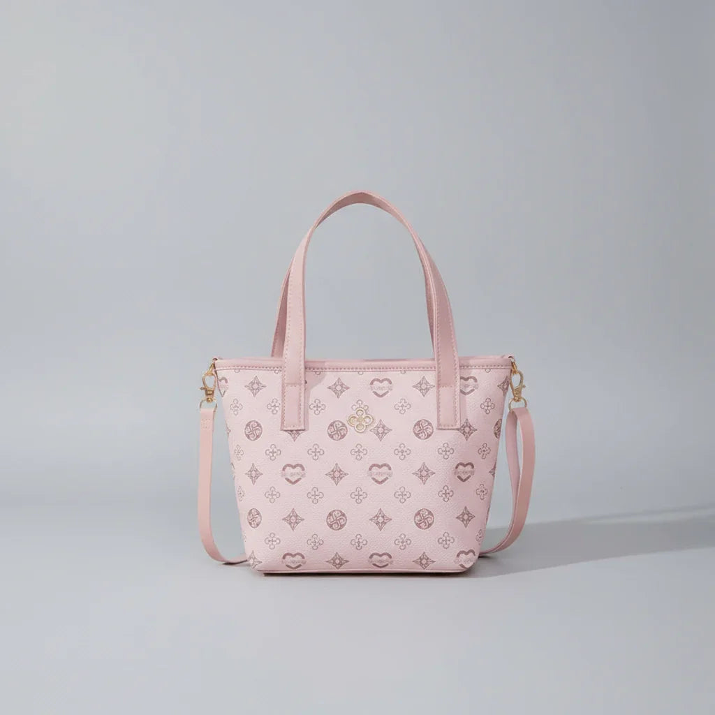 Light pink tote bag with patterned design and detachable shoulder strap on plain background