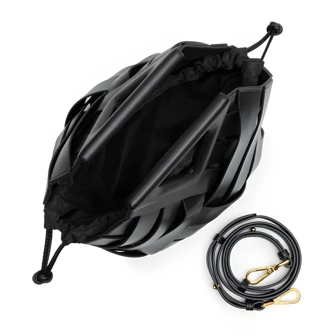 Top view of black designer bucket bag with geometric pattern and detachable strap