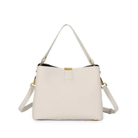 Ivory leather handbag with gold hardware and adjustable shoulder strap on white background