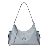 Glossy light gray shoulder bag with silver logo, side pockets, and detachable strap