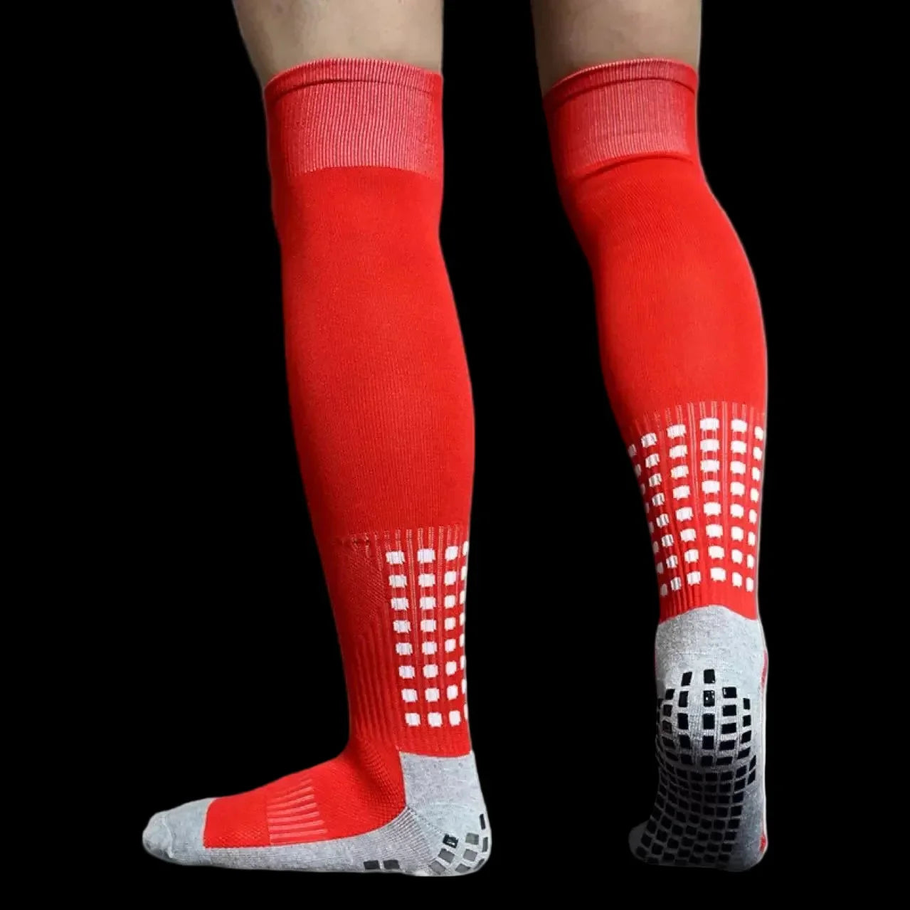 Red knee-high socks with white grid pattern and gray toes on a black background