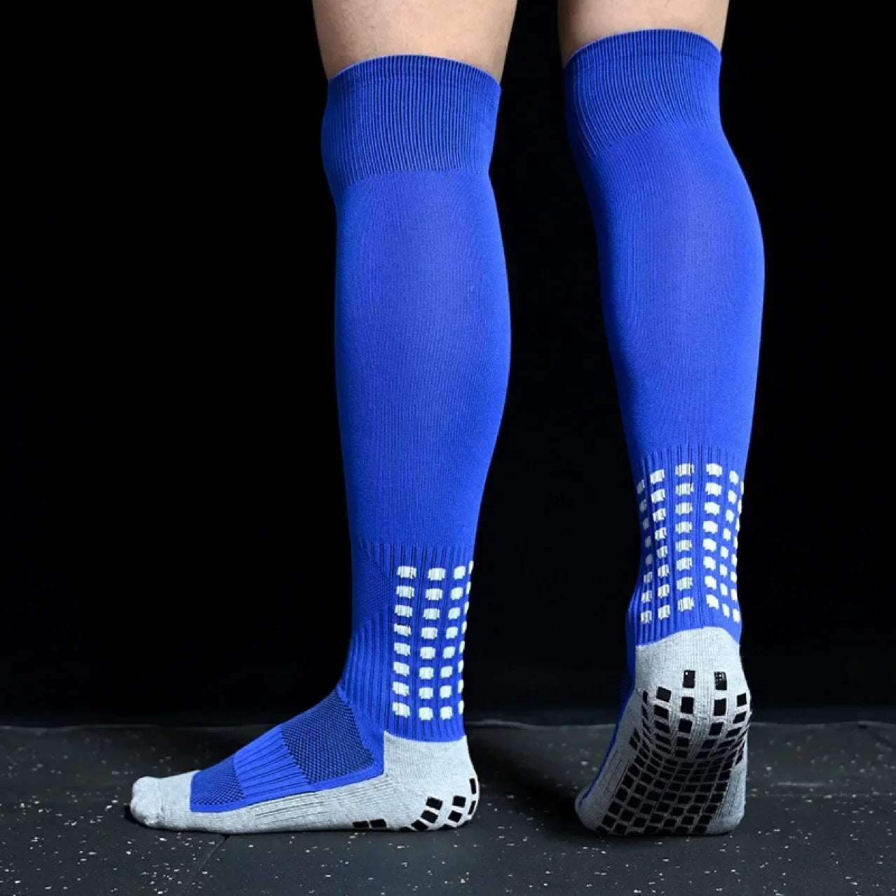 Blue knee-high socks with white grid pattern on a black background