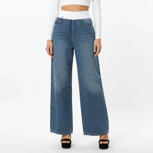 Women wearing blue wide-leg jeans on a white background