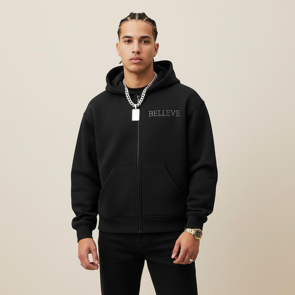Black hoodie with 'BELIEVE' text on a gray background