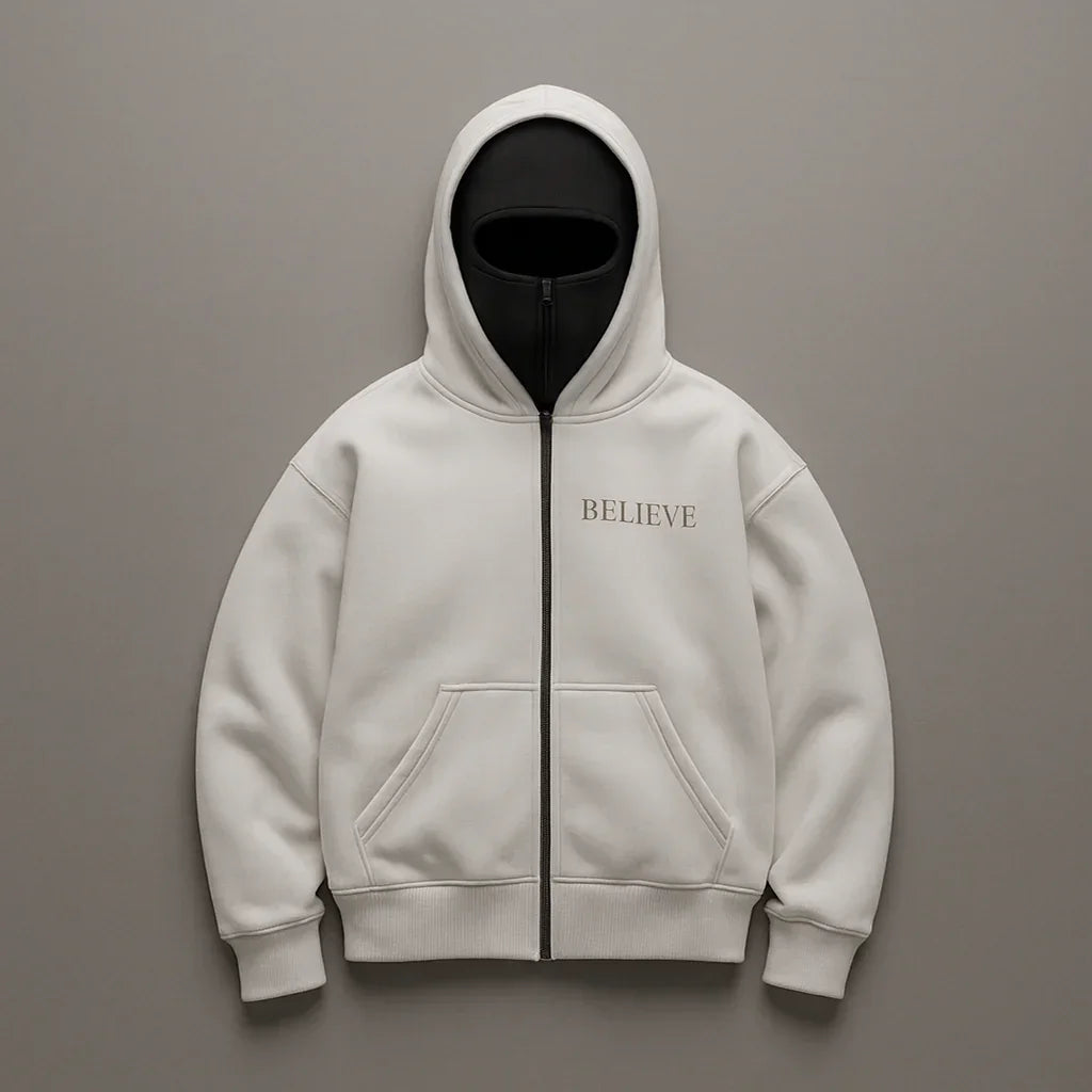 White hoodie with 'BELIEVE' text on a gray background