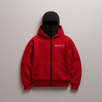 Red hoodie with 'BELIEVE' text on a gray background