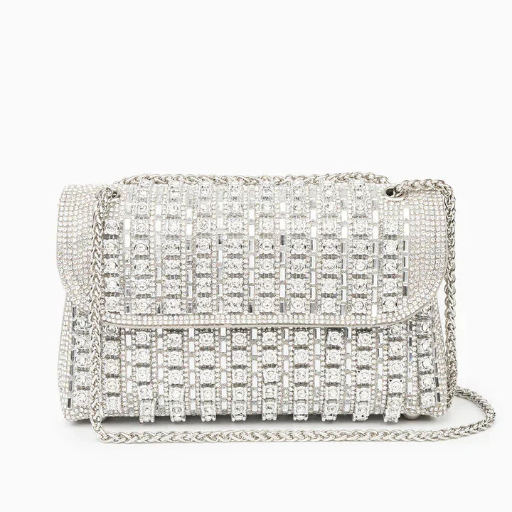 Silver rhinestone evening bag with chain strap and geometric crystal design on white background