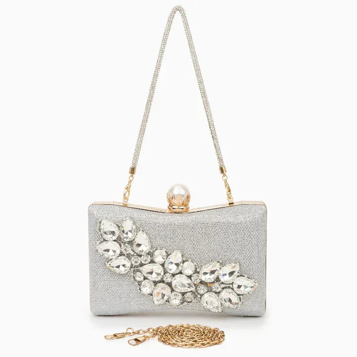 Silver clutch evening bag with crystal rhinestone accents, gold chain, and pearl clasp