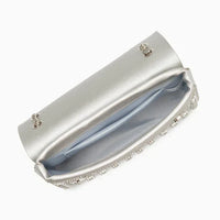 Open silver clutch bag with chain, satin lining, and rhinestone trim on white background