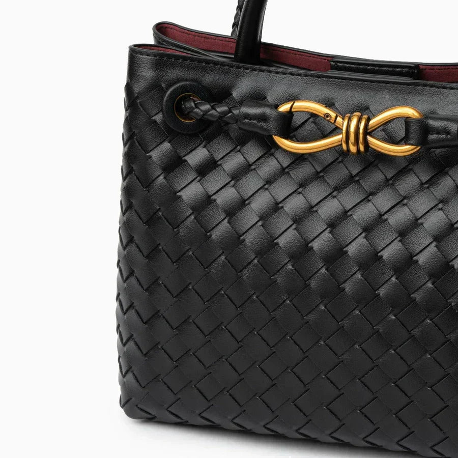 Black woven leather handbag with gold hardware and braided strap detail