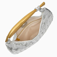 Silver woven leather clutch with gold handle and beige interior, open top view
