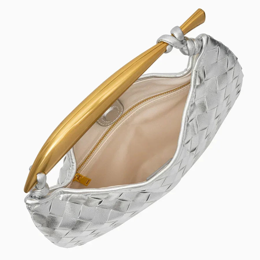 Silver woven leather clutch with gold handle and beige interior, open top view