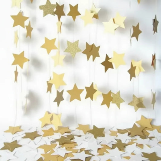 Gold and white star-shaped confetti on a white background