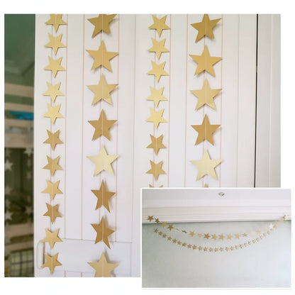 Gold star garland hanging on a white wall with a close-up of the stars.