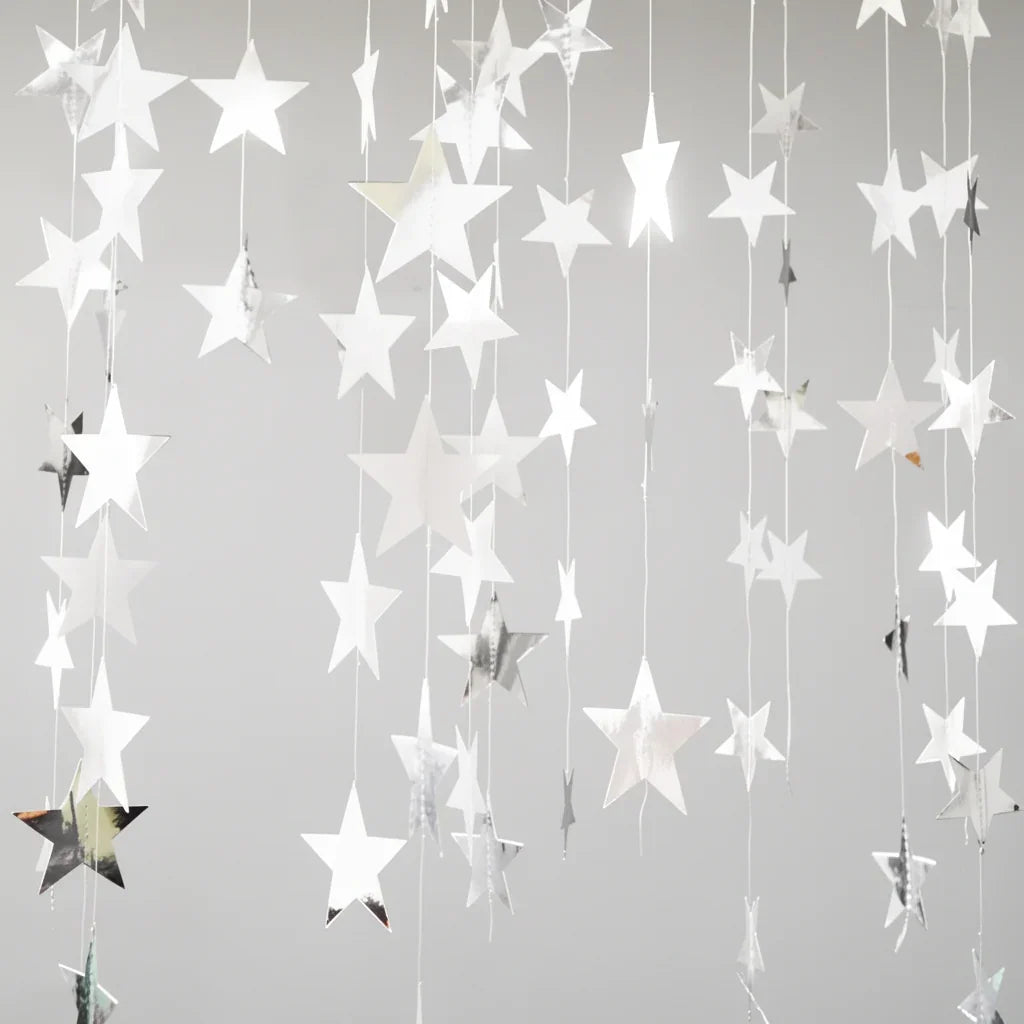 Star-shaped decorations hanging against a light gray background
