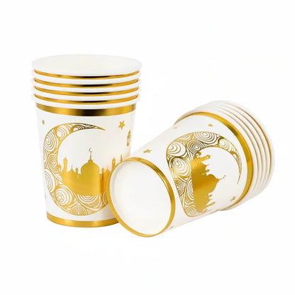 White paper cups with gold decorative patterns on a white background