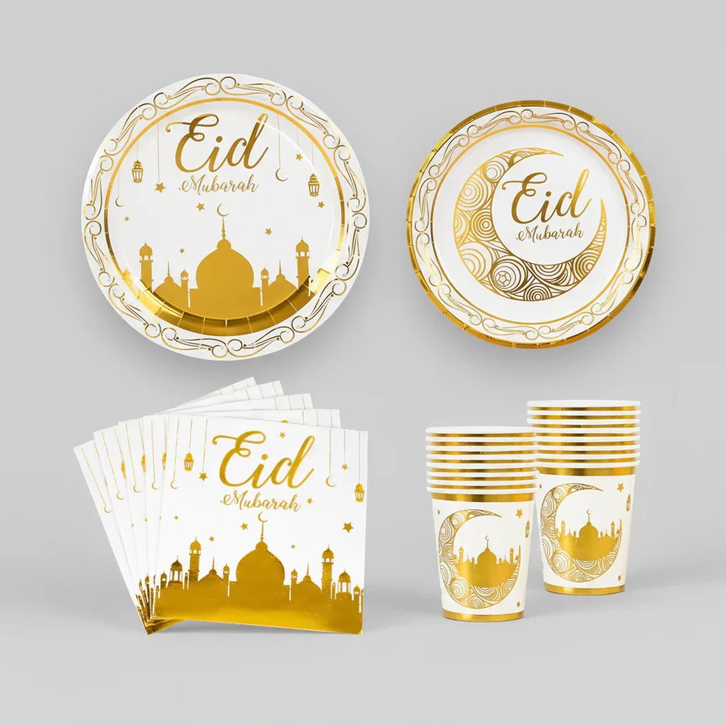 Eid Mubarak-themed partyware set with plates, cups, and napkins featuring gold designs on a white background.