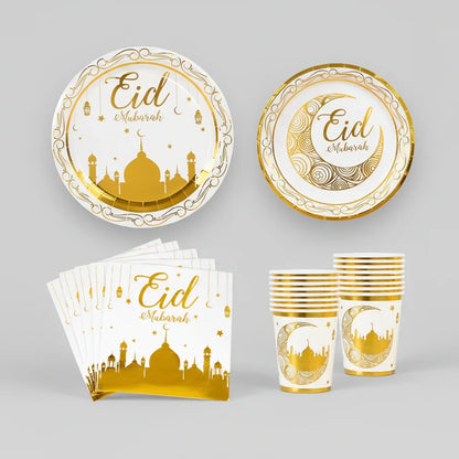 Eid Mubarak-themed partyware set with plates, cups, and napkins featuring gold designs on a white background.