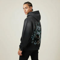 Person wearing a black hoodie with a Pitbull graphic on the back against a plain background